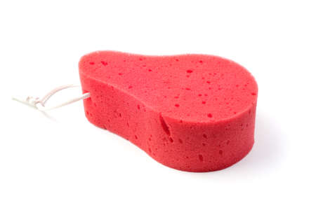 A pink pear-shaped washcloth on a white background. Accessories for the bathroom. The concept of a healthy lifestyle.の写真素材