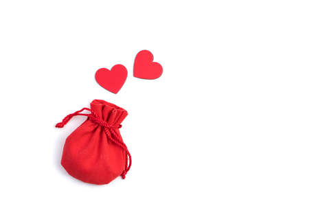 Two red hearts fly out of a gift bag on a light background. Top view with space to copy. The concept of Valentines Day.の写真素材