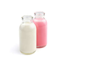 Two cocktail bottles of different colors isolated on a white background. Side view with space for copying. The concept of dairy products.の写真素材