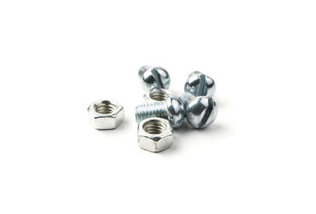 A group of bolts and nuts on a white background. Side view. Fasteners with a threaded connection.