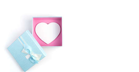 Open gift box with a white heart inside on a white background. Top view, panorama. Concept February...
