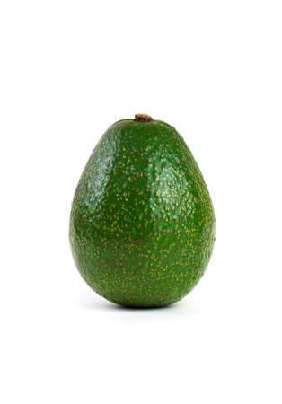Avocado whole in the skin on a white background. Side view, vertical orientation. Concept of useful...