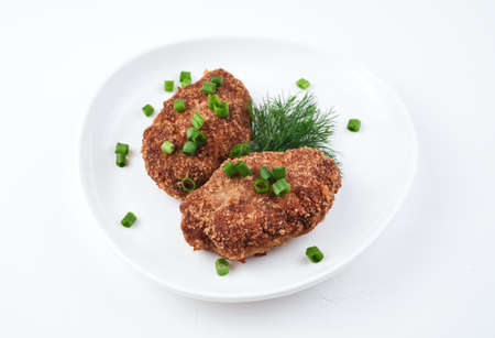Culinary background with two fresh juicy cutlets on a white background. Side view with space for...