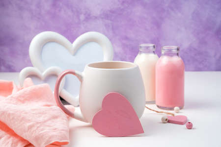 Pink heart on a coffee mug on a romantic background. Side view with space for copying. Holiday background, February 14.の写真素材