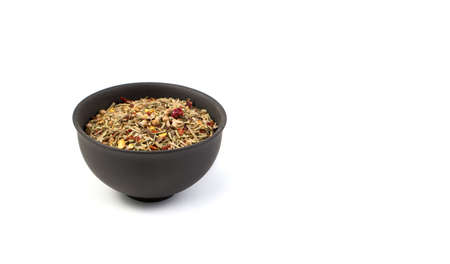A set of condiments for cooking in a brown Cup on a white background. Side view with copy space, panorama.の写真素材