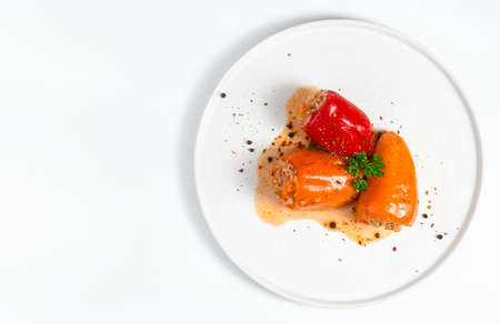 Stuffed pepper with green parsley and spices on a light background in a white plate. The view from the top. Concept of culinary backgrounds.の写真素材