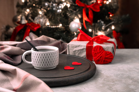 A cup of coffee with red hearts on a festive background. Side view. The concept of holiday backgrounds.の写真素材
