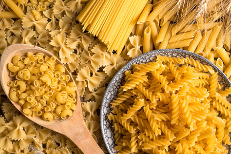 The table is covered with pasta of different varieties. The view from the top. Culinary background. The concept of food.の写真素材