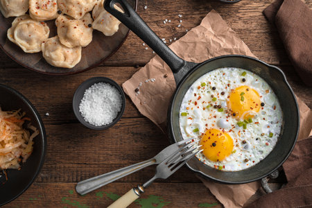 Fried eggs on a wooden background. The view from the top. The concept of cooking.の写真素材