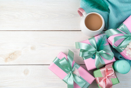 Festive background with gifts, candles and a sweater on a white wooden background. Top view, with space to copy. The concept of March 8, spring.の写真素材