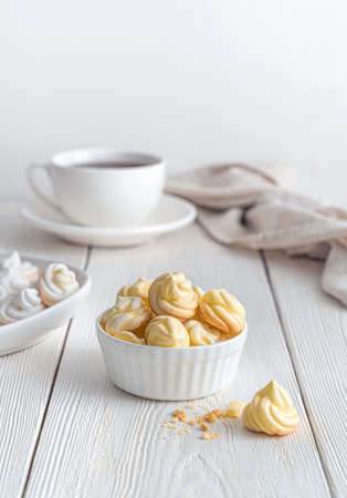 Still life with lemon meringue on a soft light background. Side view, vertical.の写真素材