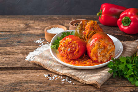 Stewed bell pepper with meat and rice on a wooden background. Healthy food. Side view, copy spaceの写真素材