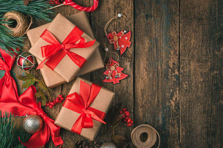 Christmas gifts on a festive background. Gift boxes with red ribbons. Top view, copy space.の写真素材