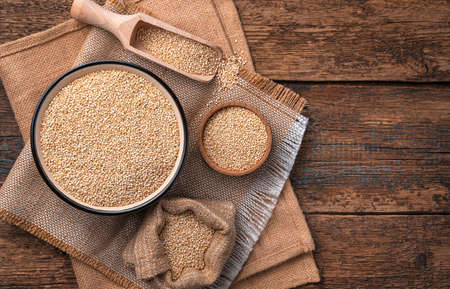 Useful quinoa seeds in a bowl on a natural background with space for copying. top view. Health food.