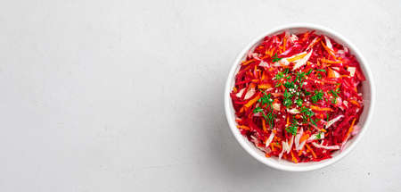 Beetroot salad with cabbage and carrots seasoned with dill and sesame seeds. Healthy, vegetarian...