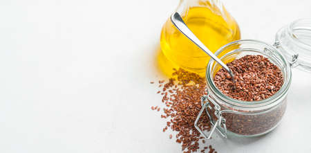 Linseed oil and flax seeds. Side view, copy space. Healthy organic food.の写真素材