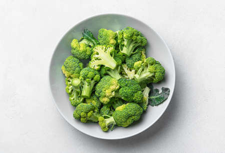 Broccoli in a plate on a gray wooden background. Cooking broccoli. Top view. Healthy foodの写真素材