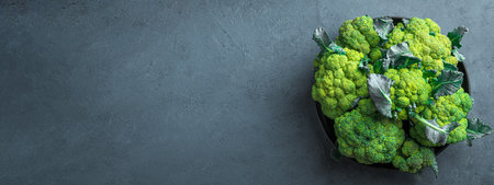 Broccoli in a black plate on a graphite background. Top view, copy spaceの写真素材