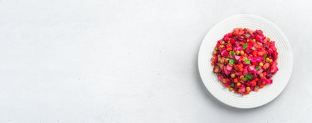 Vegetable salad vinaigrette on a gray background. Traditional festive salad. Top view, copy space.の写真素材