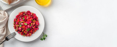 Vegetable salad with peas and sauerkraut on a gray background. Traditional festive salad - vinaigrette. Top view, copy space.の写真素材