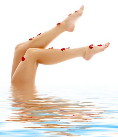 beautiful legs of lady relaxing in blue waterの写真素材