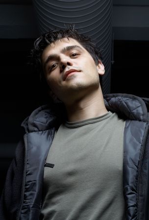 dark portrait of street mobster in industrial building basementの写真素材