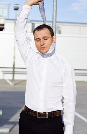 picture of crying businessman hanging himself on tieの写真素材