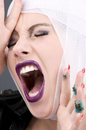 picture of screaming wounded woman face over greyの写真素材