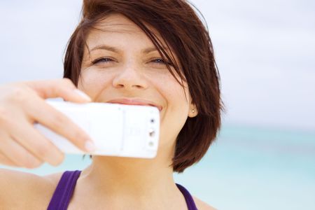 picture of happy woman using phone camera