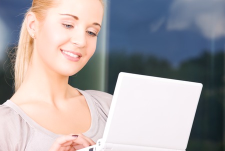 picture of happy businesswoman with laptop computerの写真素材