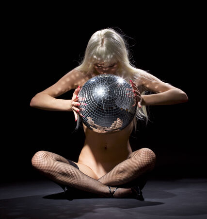 party dancer girl in fishnet stockings with disco ballの写真素材