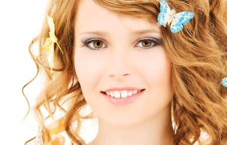 picture of teenage girl with butterflies over whiteの写真素材