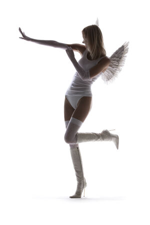 backlight picture of white lingerie angel on high heelsの写真素材