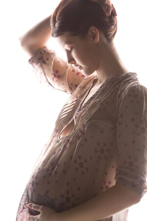 silhouette backlight picture of pregnant beautiful womanの写真素材
