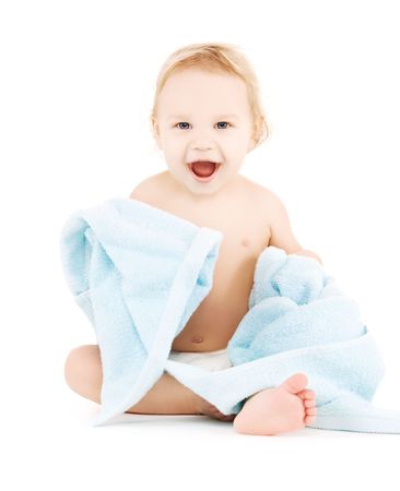 picture of baby boy with blue towel over whiteの写真素材