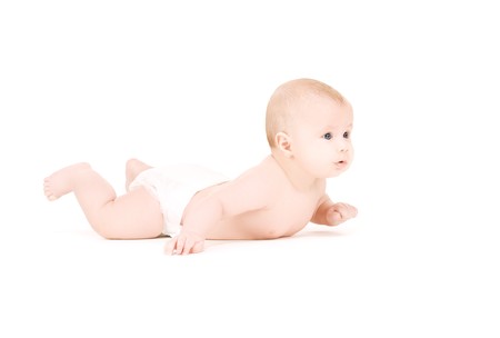 picture of laying baby boy in diaper over whiteの写真素材