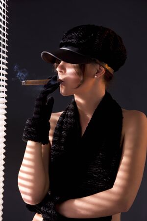 sexy woman in black astrakhan smoking cigar