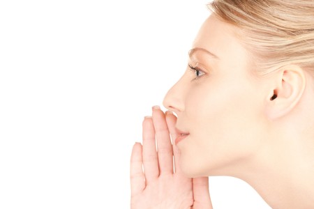 bright picture of young woman whispering gossipの写真素材