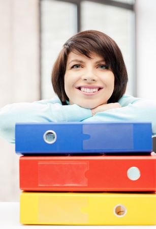 bright picture of beautiful woman with foldersの写真素材