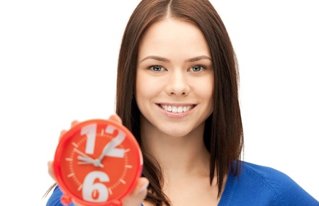 bright picture of woman holding alarm clockの写真素材