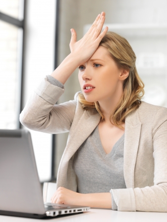 picture of stressed woman with laptop computerの写真素材