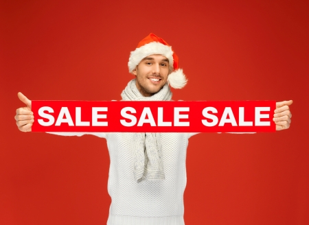 bright picture of handsome man in christmas hat の写真素材