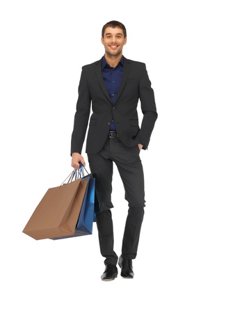 picture of handsome man in suit with shopping bags の写真素材