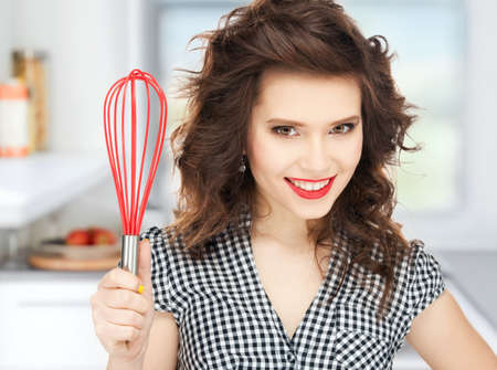 bright picture of lovely housewife with cooking eqipment の写真素材