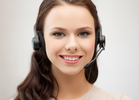 friendly female helpline operator with headphonesの写真素材