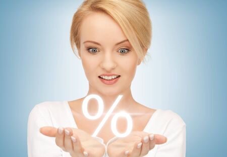 beautiful woman showing sign of percent in her handsの写真素材