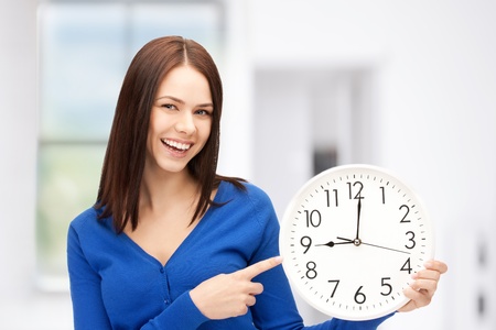 bright picture of woman holding big clock bright picture of woman holding big clock