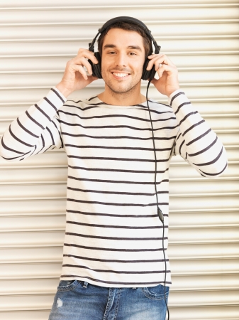 handsome man in casual clothes with headphonesの写真素材