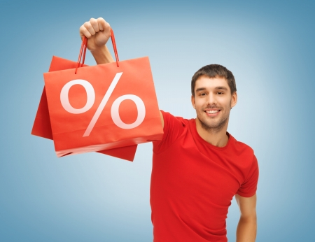 picture of handsome man with shopping bagsの写真素材