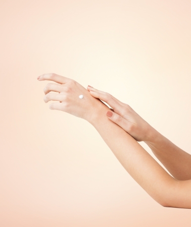 close up of female soft skin hands with cremeの写真素材